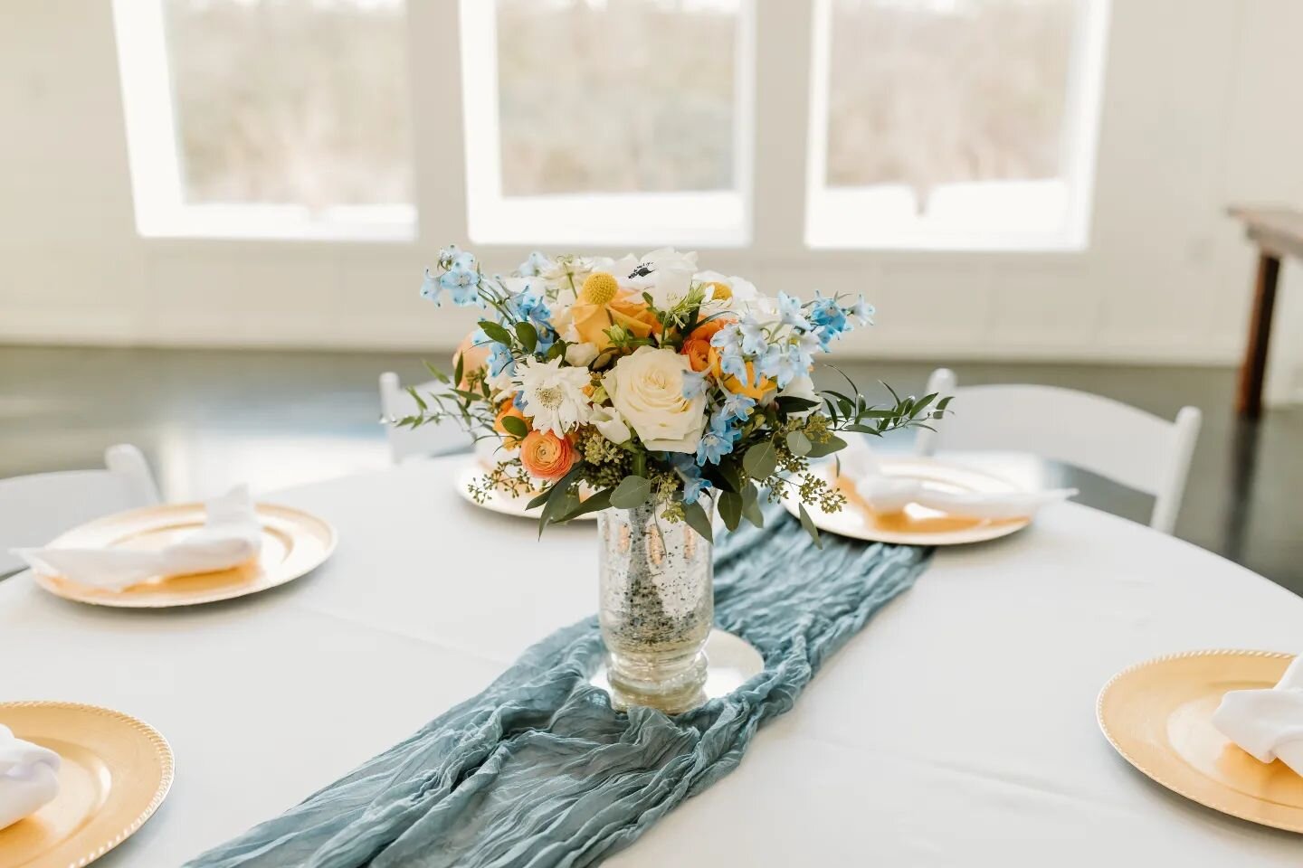 A Golden Charger option, placed with powder blue runner, and one of the many vases available for rent with our wedding packages. Send us an email: events@eighttenranch.com for a tour! Mention #goldencharger for a special gift with your booking schedu