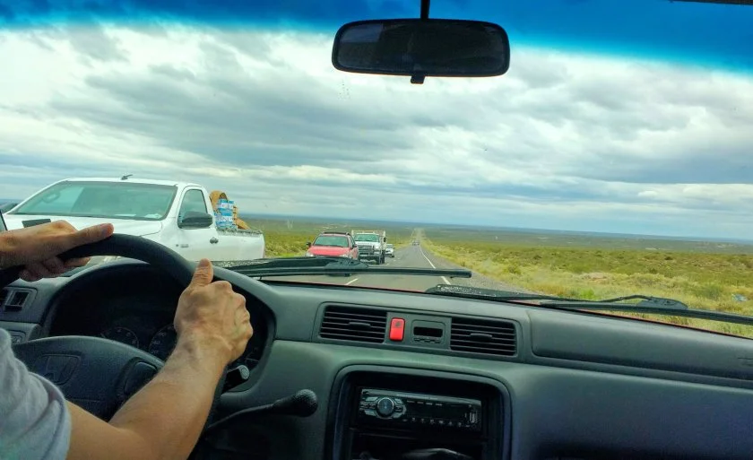 My father driving down one of the straight, endless highways of the Pampas.
