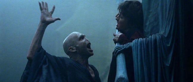 Ralph Fiennes as Voldemort and Daniel Radcliffe as Harry Potter in Harry Potter and the Goblet of Fire (2005, Warner Bros.)