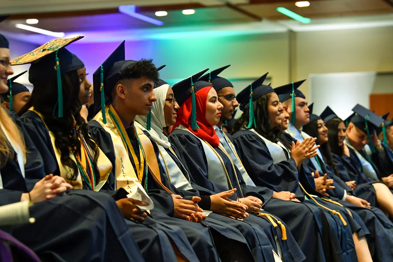 STEM Prep valedictorian Xeria Keys (left) sits next to salutatorian Abram Agaiby during the graduation ceremony. They are among 95 members of STEM Prep’s inaugural graduating class, members of which collectively received 152 scholarships valued at over $3 million.