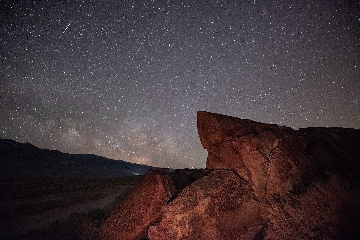 A Tau Herculid meteor with the Milky Way from the Volcanic Tablelands in California. Saw three decent fireballs near the peak, opposite the camera of course! 
The petroglyphs were inscribed by the Paiute-Shoshone people long ago, unfortunately they h