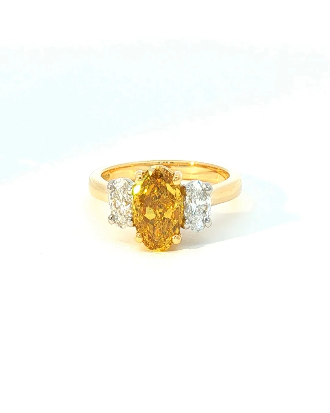 Fancy Deep Yellow Oval Diamond Three Stone Ring
