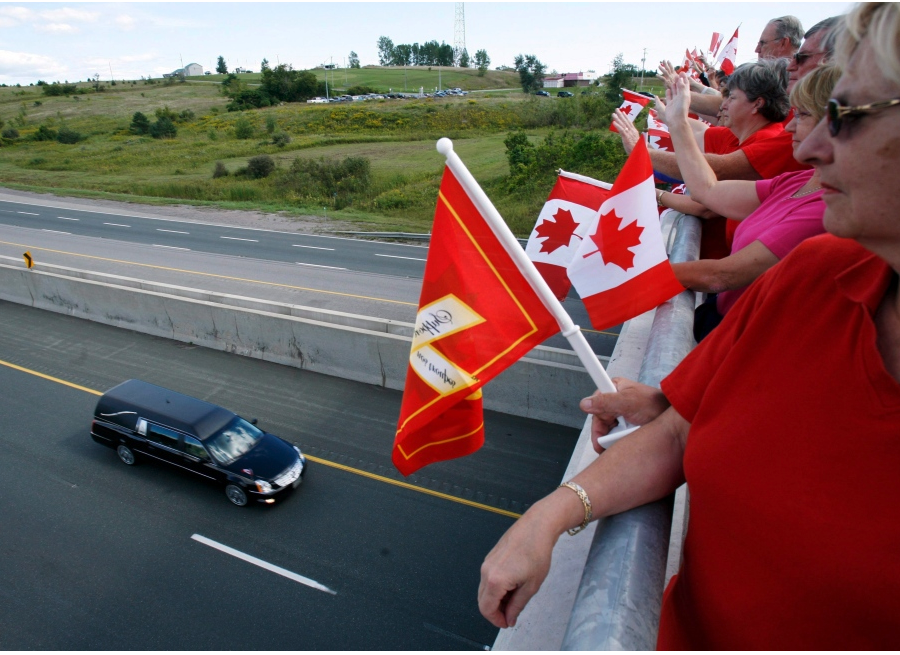 People stand along an overpass above the Highway of Heroes in this undated file photo. - CTV NEWS