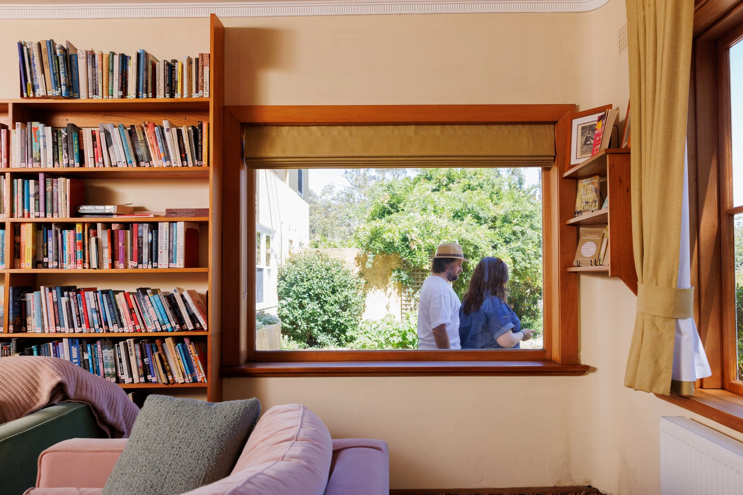 Varuna lounge room with books and two people walking past the window