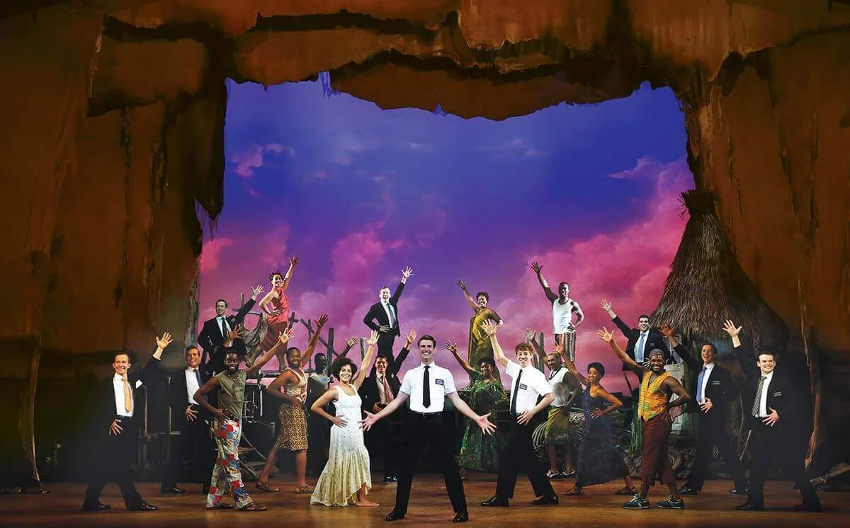 Ryan Bondy, Zahra Newman, Nyk Bielak and company in The Book of Mormon. © Jeff Busby.