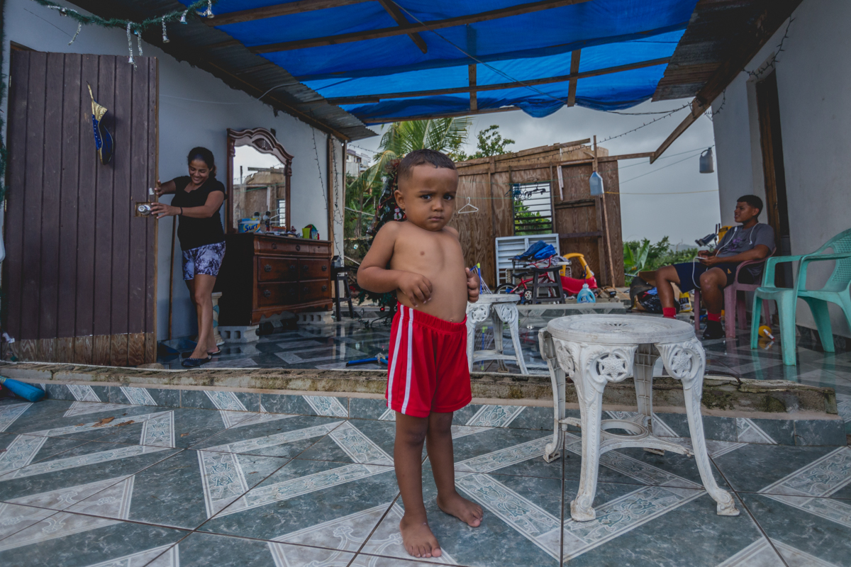 Virginia (39) and her son Oscar Manuel (3), spend their afternoon in what is left of their home, a two-walled house without a roof. During the months following the hurricane, not having a roof became very problematic during very sunny days, or the daily rainstorm. Virginia and Oscar have twice already visited the hospital for suffering severe sunburns. Virginia now has some blue tarps for a roof - placed by the support of a religious organization. December 27, 2017