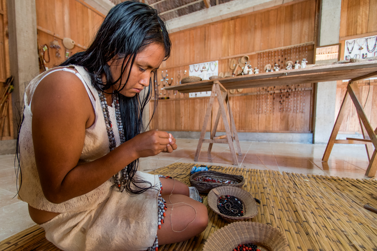  Maria, 19, works on her crafts as she wears a traditional dress used in dances with the other women of the native community. Rita is the first-ever, female advisor to the chief of the community, and together they created the first life plan for the 