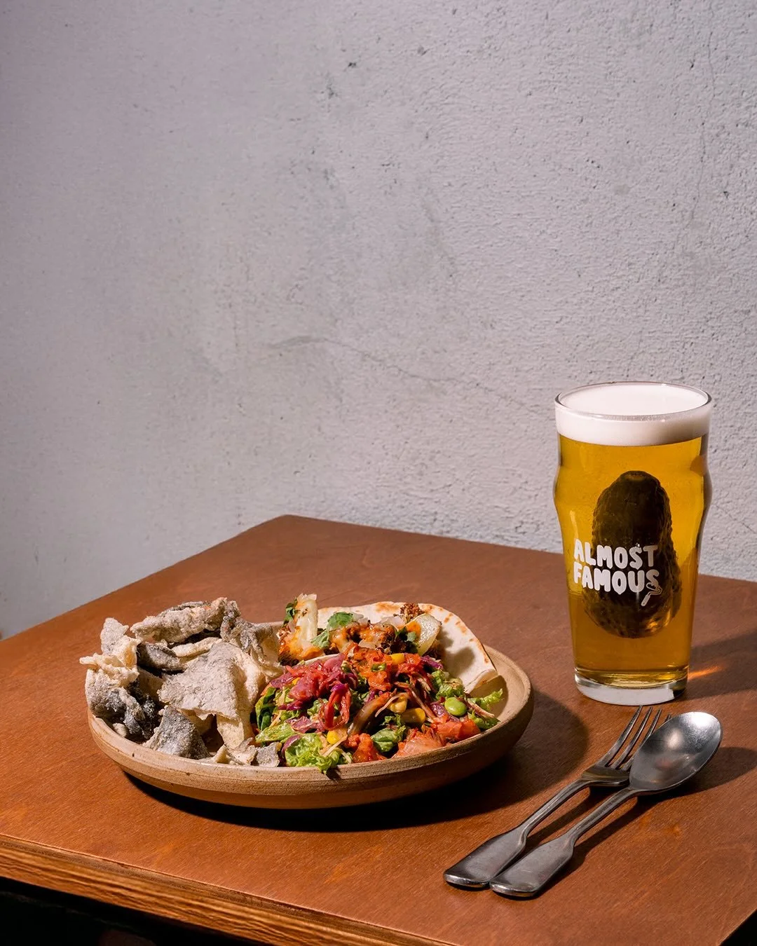 A healthier choice.
(Relative to worse decisions.)

Protein &mdash; tacos.
Veggies &mdash; salad.
Fats &mdash; chicken skin.
Carbs &mdash; beer.

Because 1 drink is healthier than 10.
And meat with greens is basically balance.

Almost Famous.
Doing o