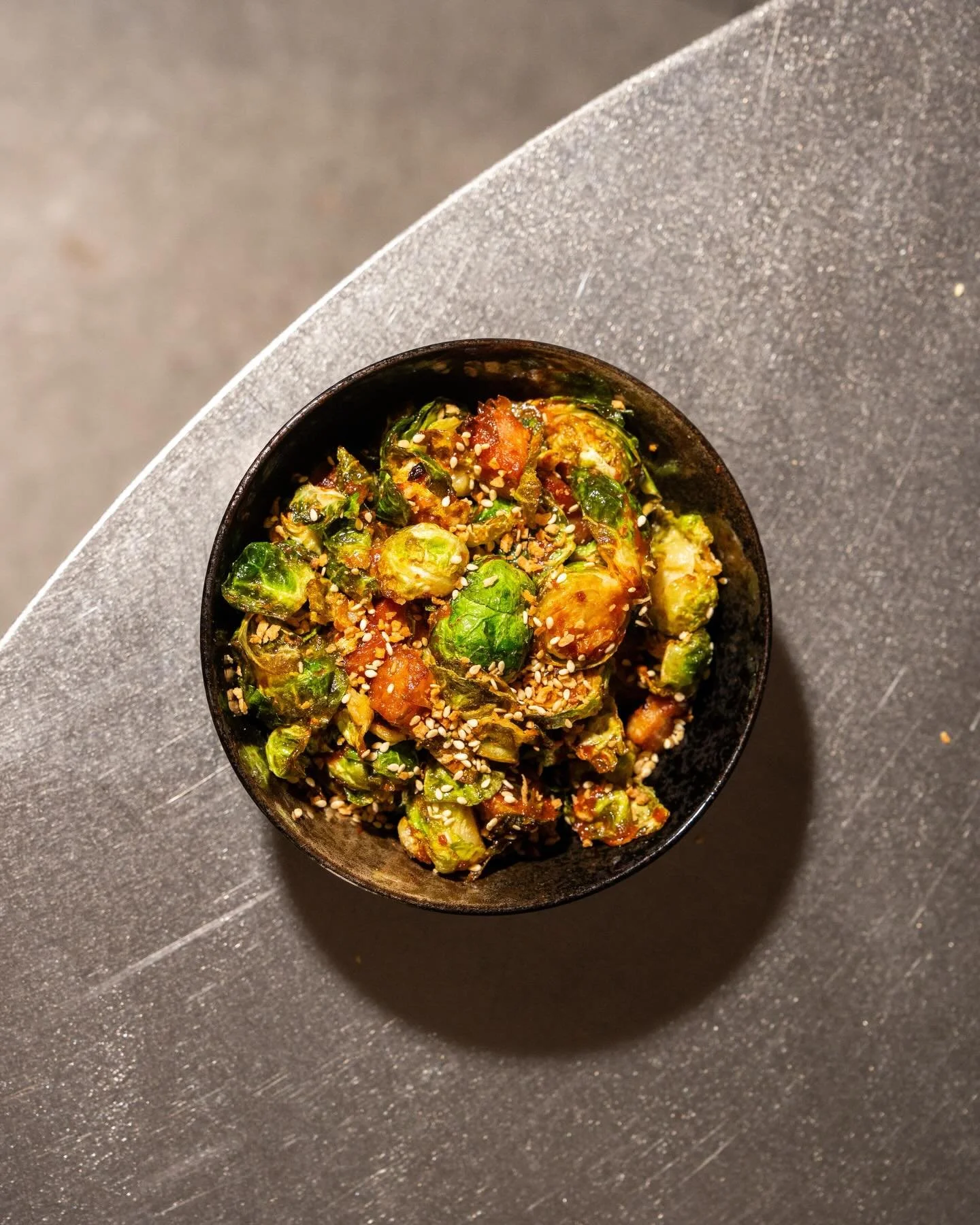 Fried Brussels.

Lardon for depth.
Ssamjang for heat.
Fried garlic for the final hit.