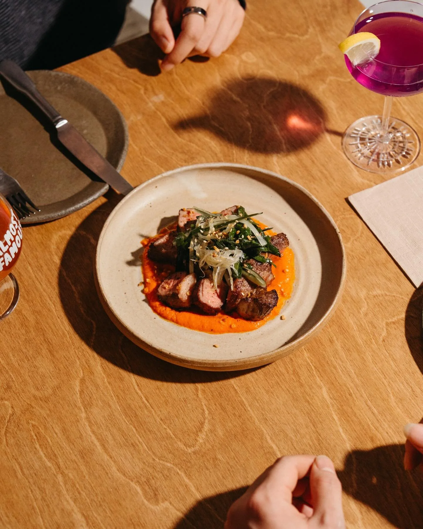 Pork Collar.

Built for the middle of the table.
Garlic romesco ssam sauce underneath,
chive salad and fried garlic over the top.

Charred, tender, and meant to move.

Order it for the table.
Let it travel.