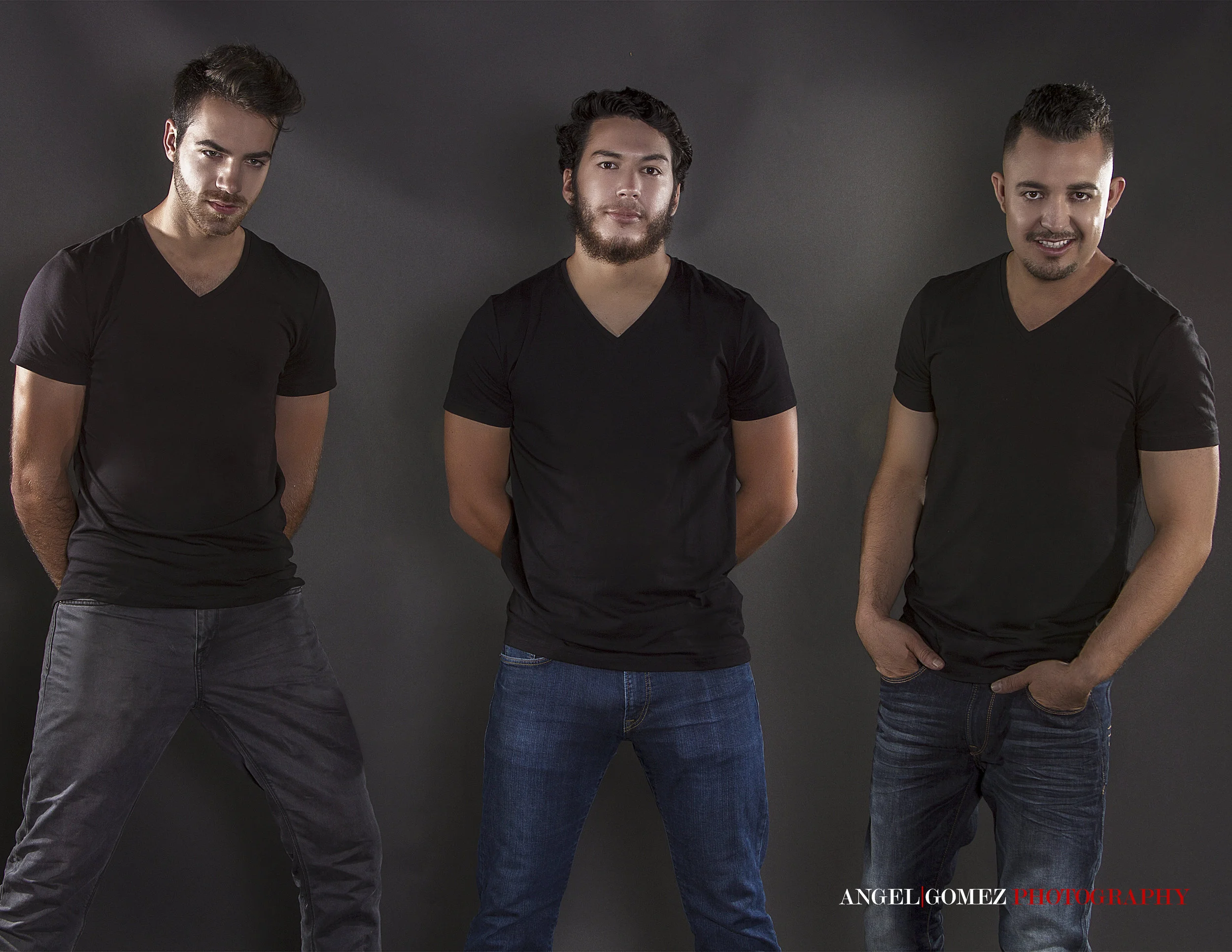Three young men standing against a dark backdrop, dressed in black t-shirts and jeans, posing confidently for a photo shoot.