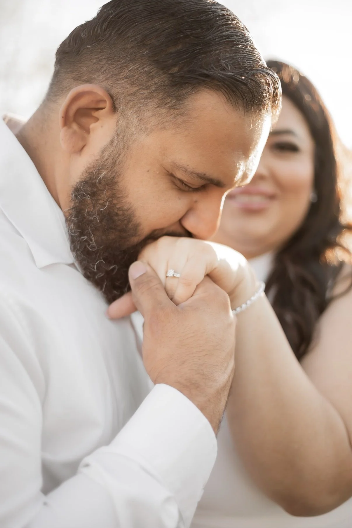 Engagement photo of a couple in white outdoors
