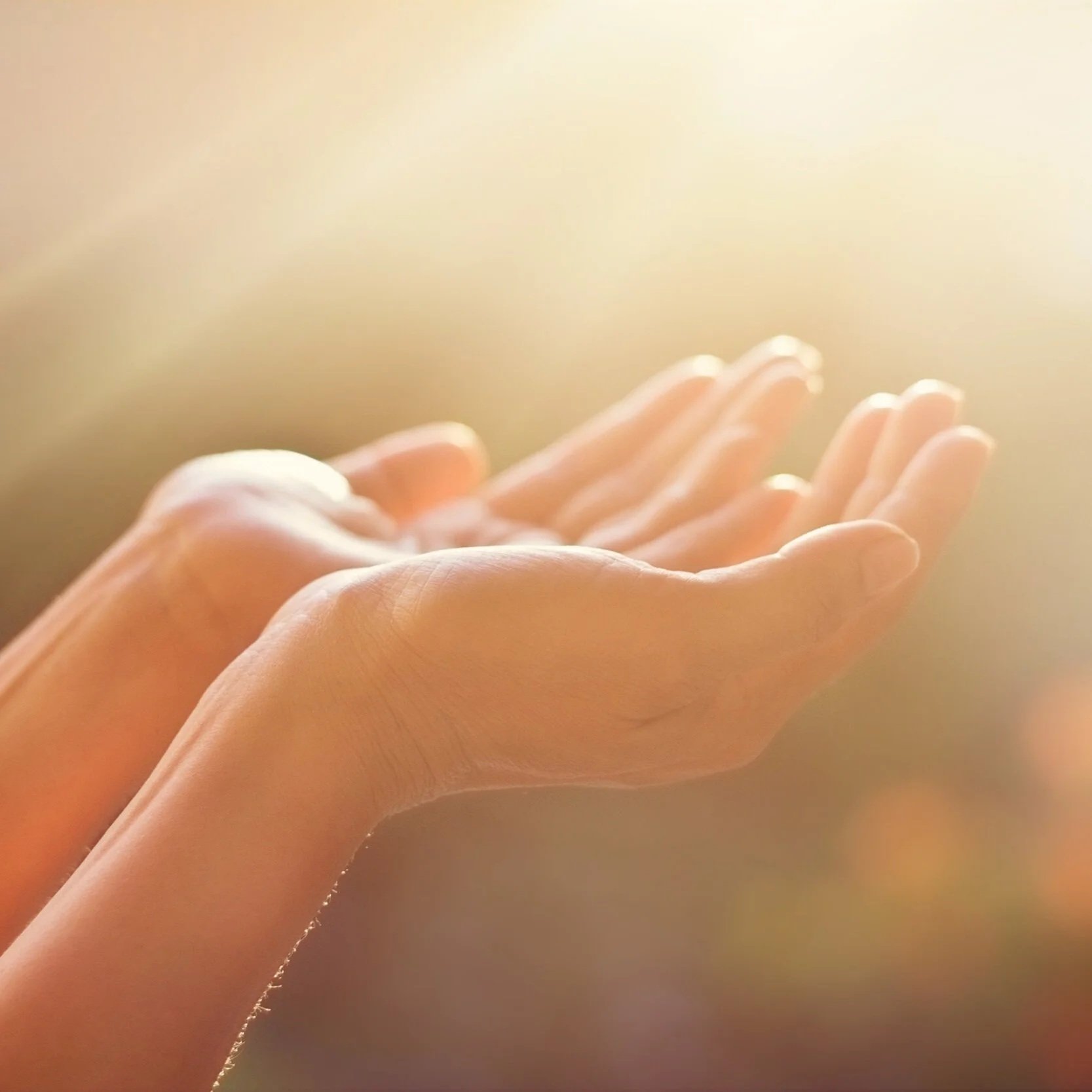 hands open to golden light pouring down like divine energy