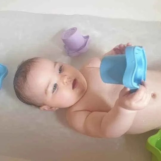 green toys recycled plastic stacking cups in bath with baby