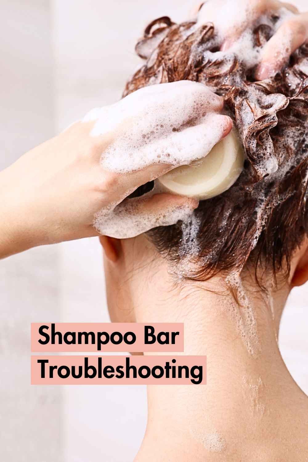 a woman washing red hair with a shampoo bar, there is later on her hands and the words "troubleshooting shampoo bars" underneath