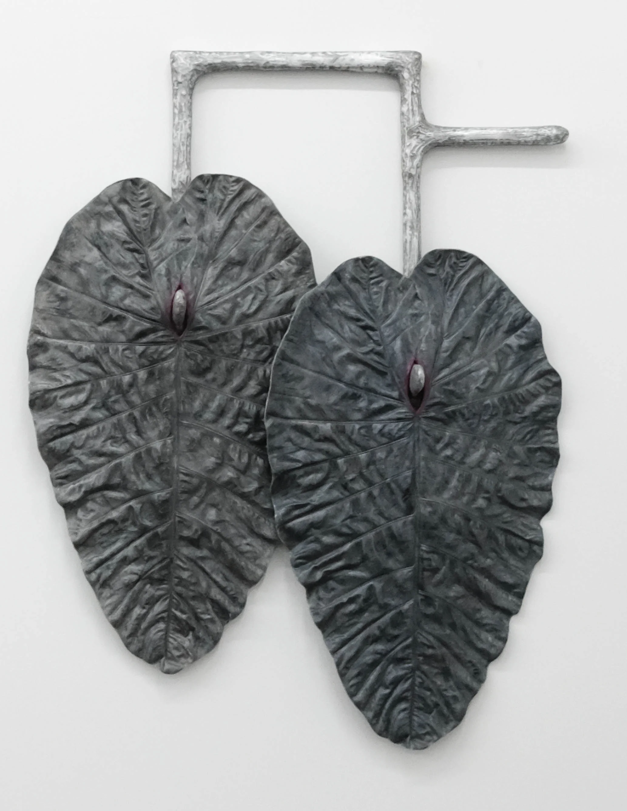 Karen Lofgren Like This I See You in Dreams (como lo cura, locura) , 2018 polyurethane castings of Amazonian medical plant leaves (la pataquina negra), aluminum powder, embedded wool, fiberglass, on cast aluminum 52 x 40 x 9 in (132.1 x 101.6 x 22.9 cm)