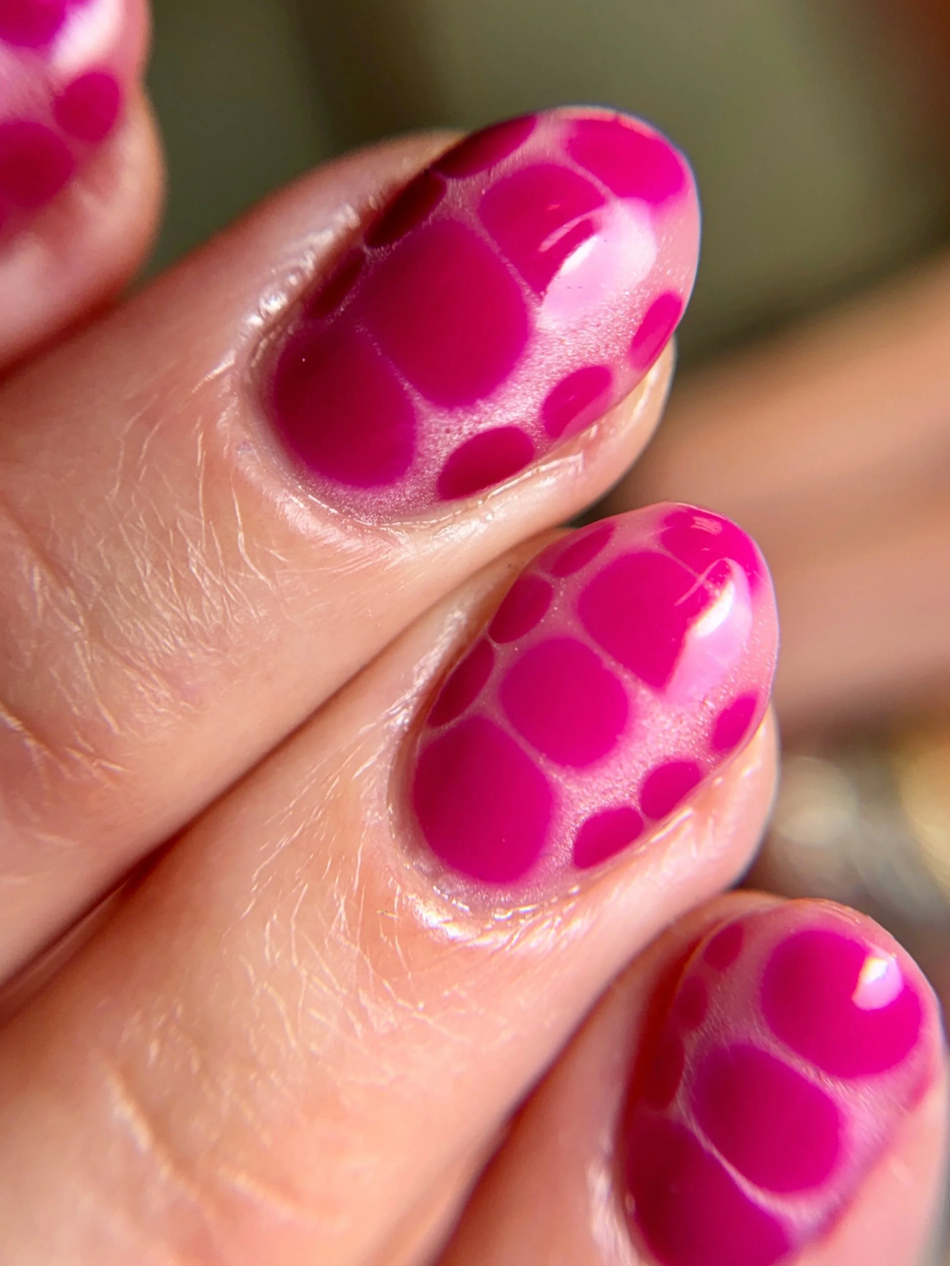 Structured gel manicure with bright pink crocodile print nail art on short natural nails.