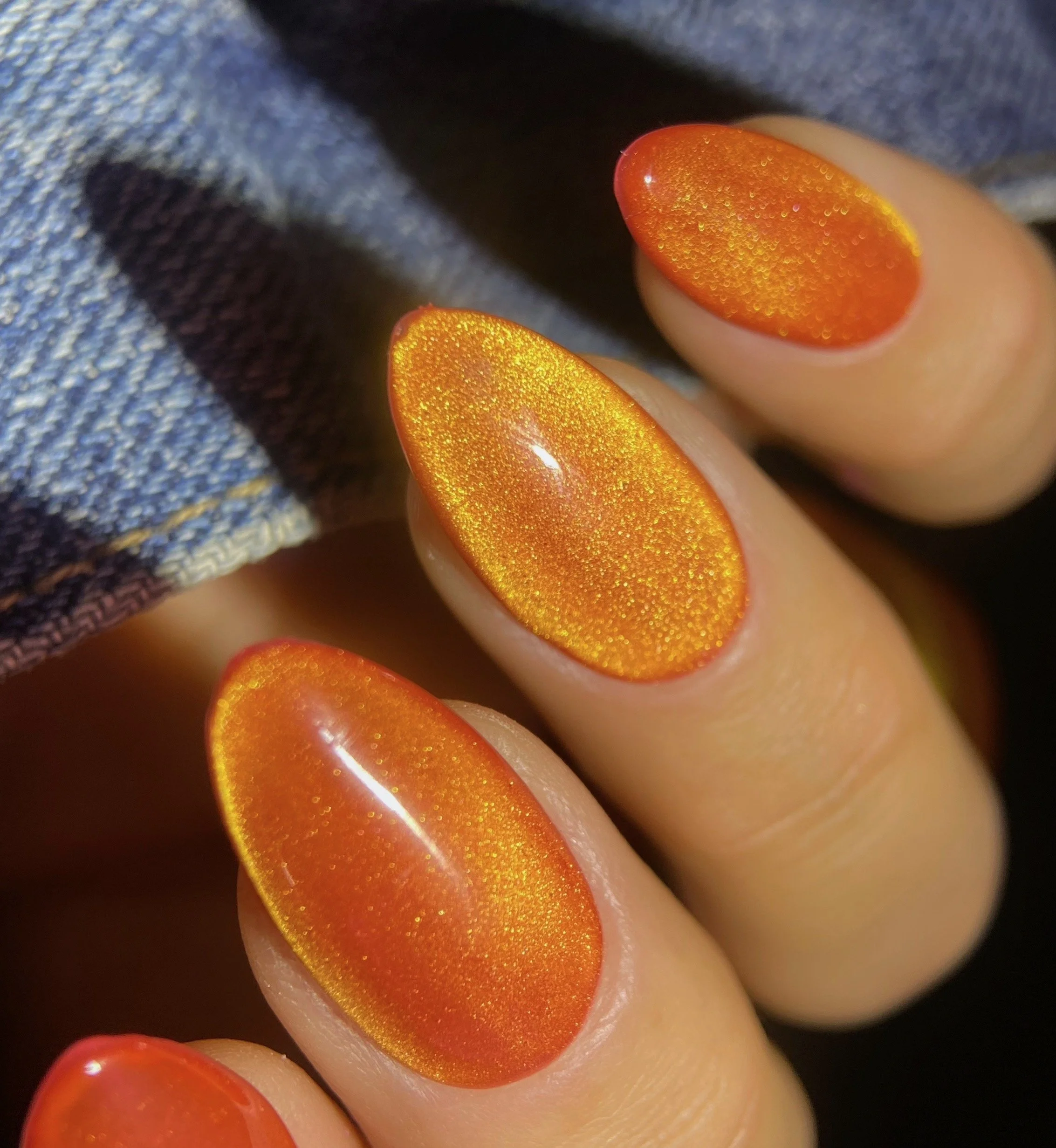 KOKOIST GM-04 Koko's Comet Galaxy Magnet gel swatch with a vivid orange base and golden magnetic shimmer.