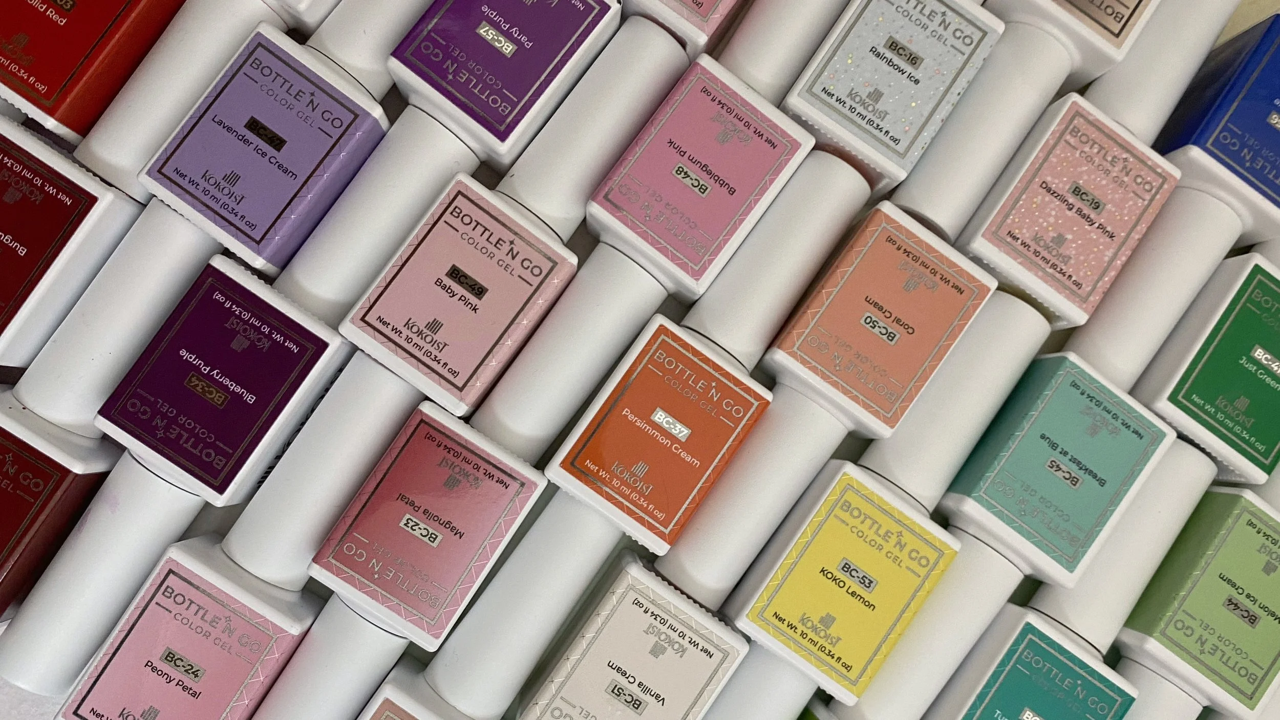 Flat lay of Kokoist Bottle’n Go Japanese gel color collection featuring pastel, glitter, syrup, and cream bottled gel shades