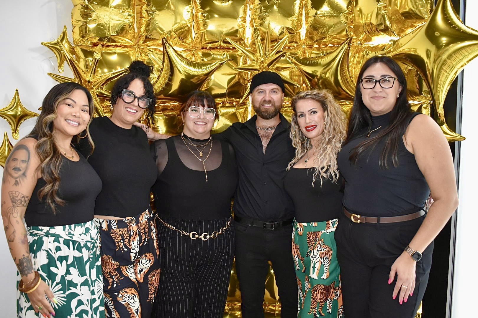 Expert panelists posing for a group photo in front of the gold balloon backdrop at The Mani Mixer 2026 in Chicago.