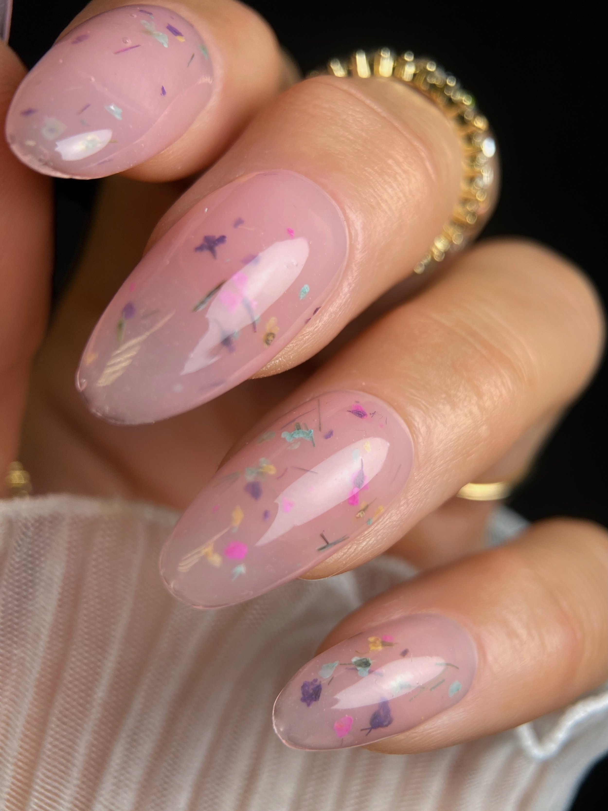 KOKOIST Botanical Flower Gel BF-05 Milky Pink swatch with colorful dried flower pieces in a translucent pink-peach base.