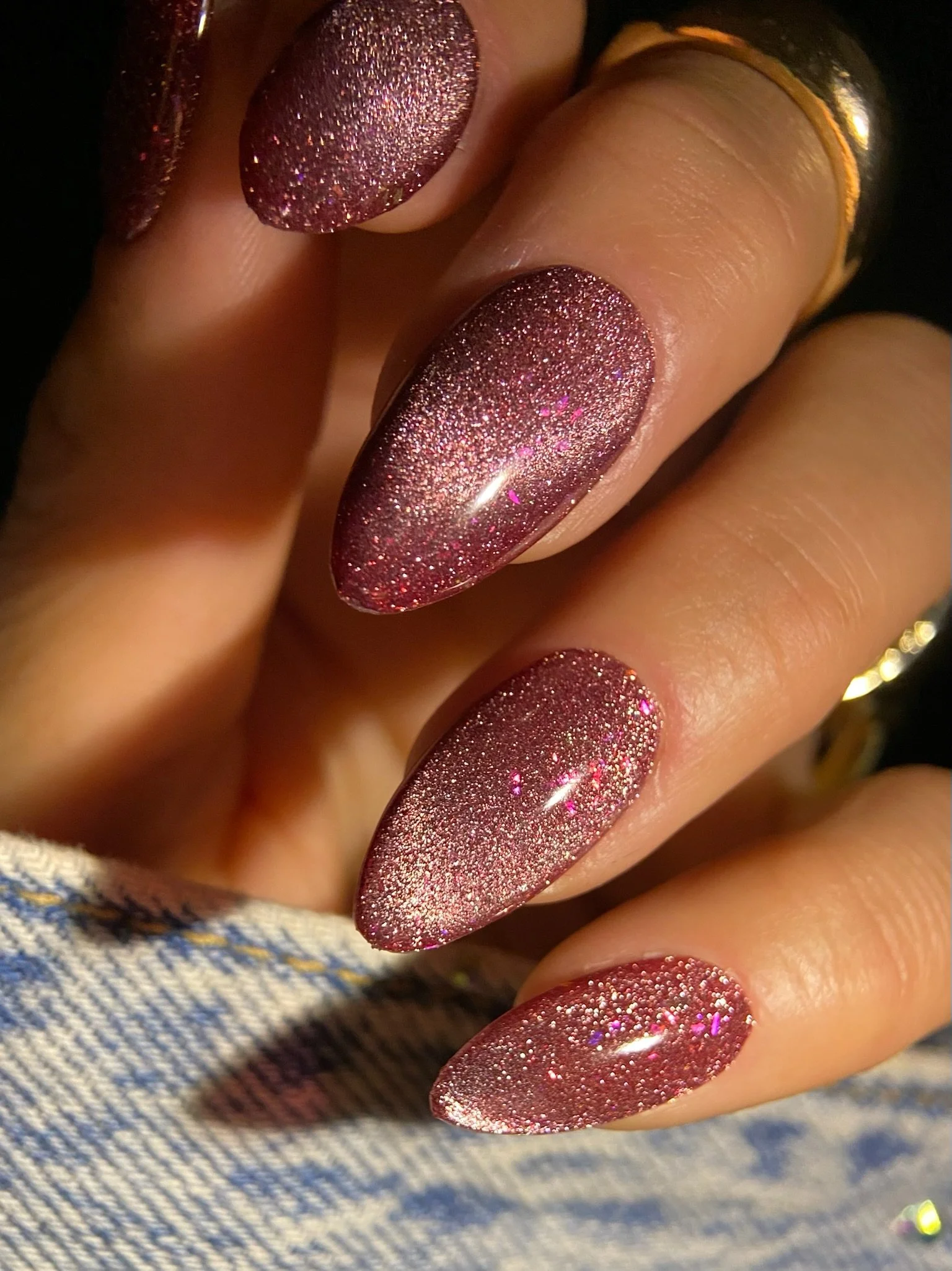 Manicured hand displaying magnetic nail art from the Nail Thoughts Zodiac Collection.