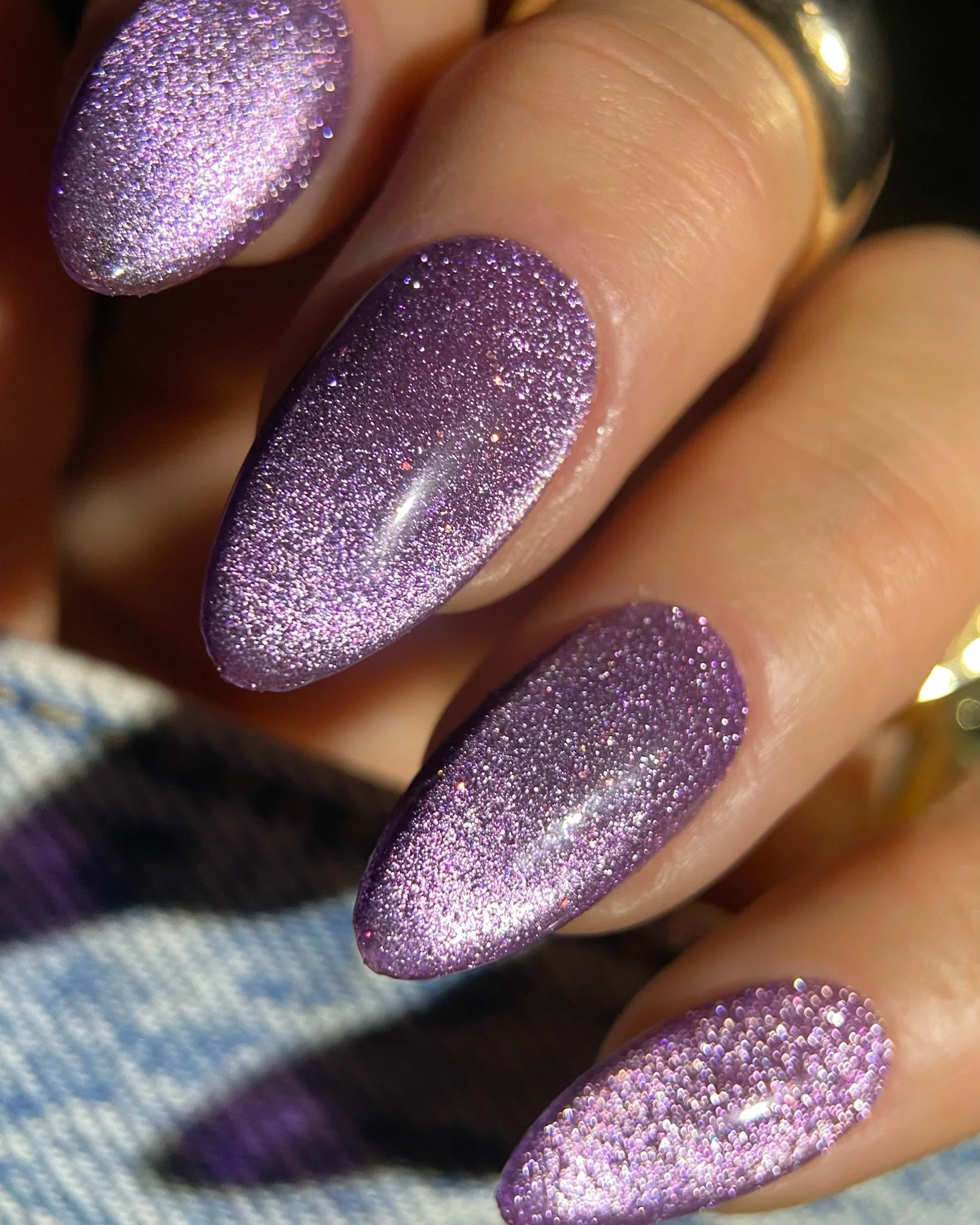 Hand with purple cat-eye nails
