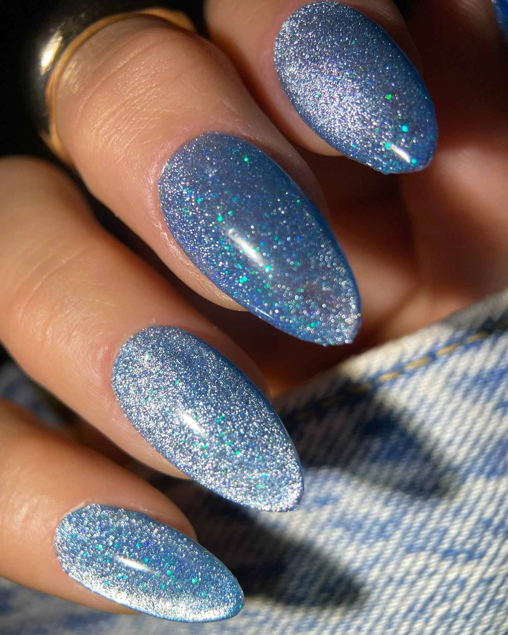 Close up of hand with blue sparkly nails