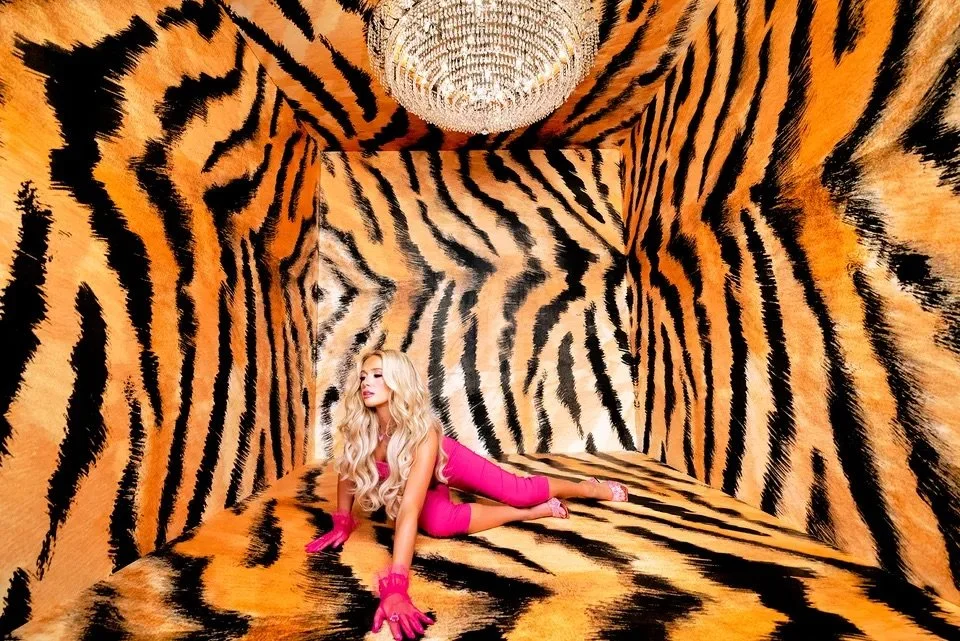 Promotional image of Megan Moroney in a tiger-striped room that inspired this tiger nail art tutorial.