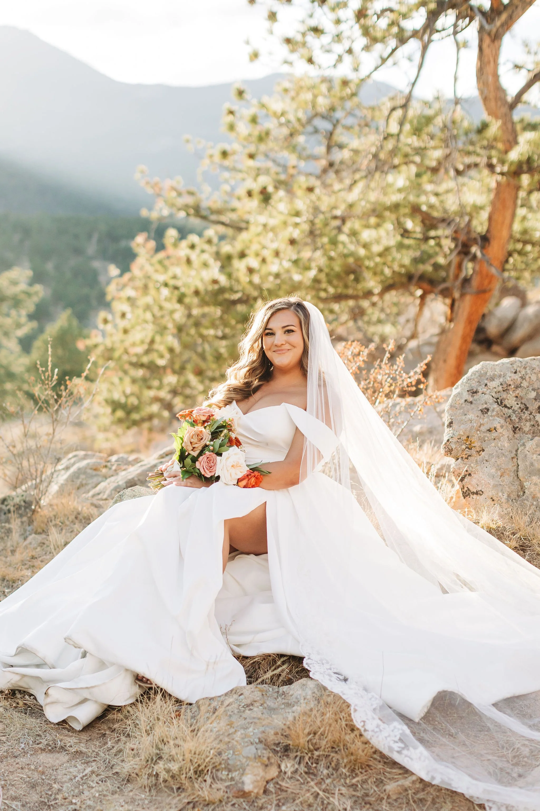 Colorado wedding photographer - bridal sitting on rock in Rocky Mountain National Park