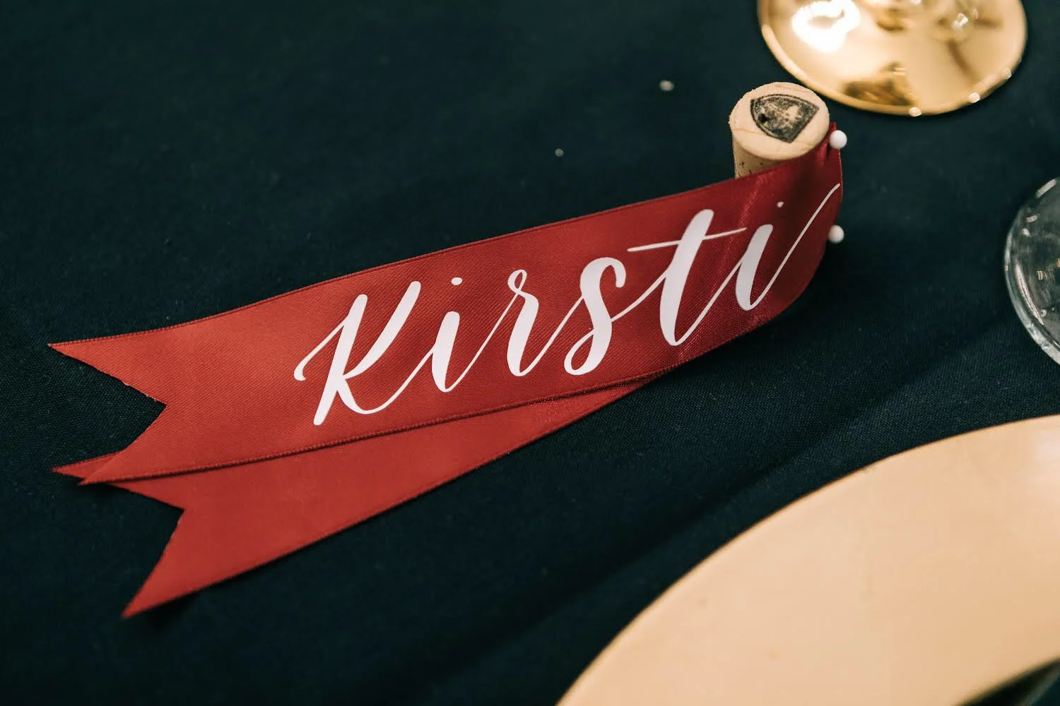 I designed these place card ribbons for a bride in the Arizona area for her wedding in the beginning of this year. Each guest got their own name lettered on ribbon in either a crimson red, gold or black ribbon.