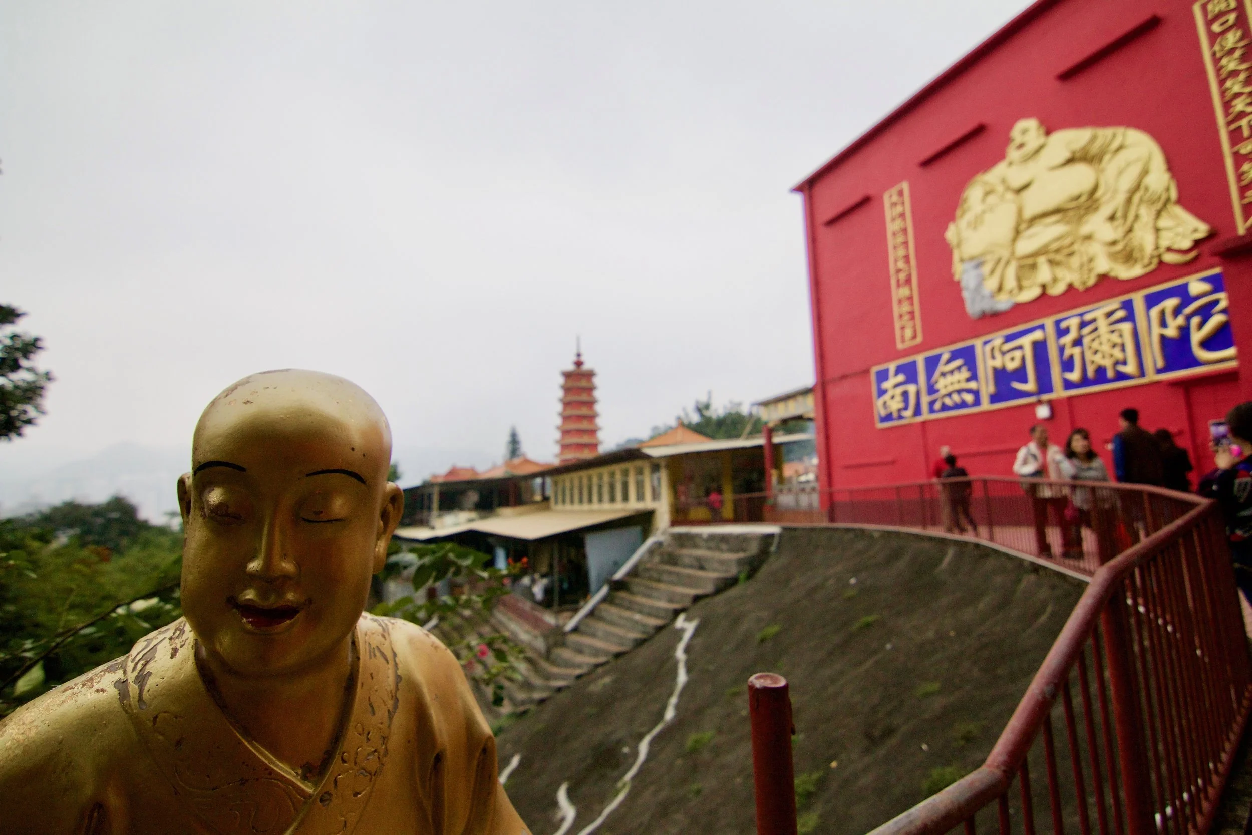 Statue near the top of Ten Thousand Buddhas Monastery, Hong Kong. Human facial recognition is more than just recognizing who it is. We also convey emotions, like a smile.