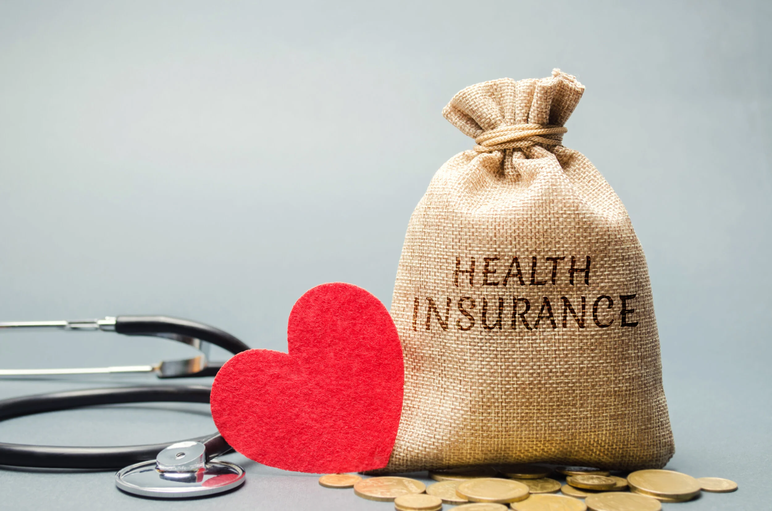 Money bag with coins and the inscription Health Insurance and a heart with a stethoscope. The concept of medical insurance of life, family, health. Healthcare. The accumulation of money. Saving