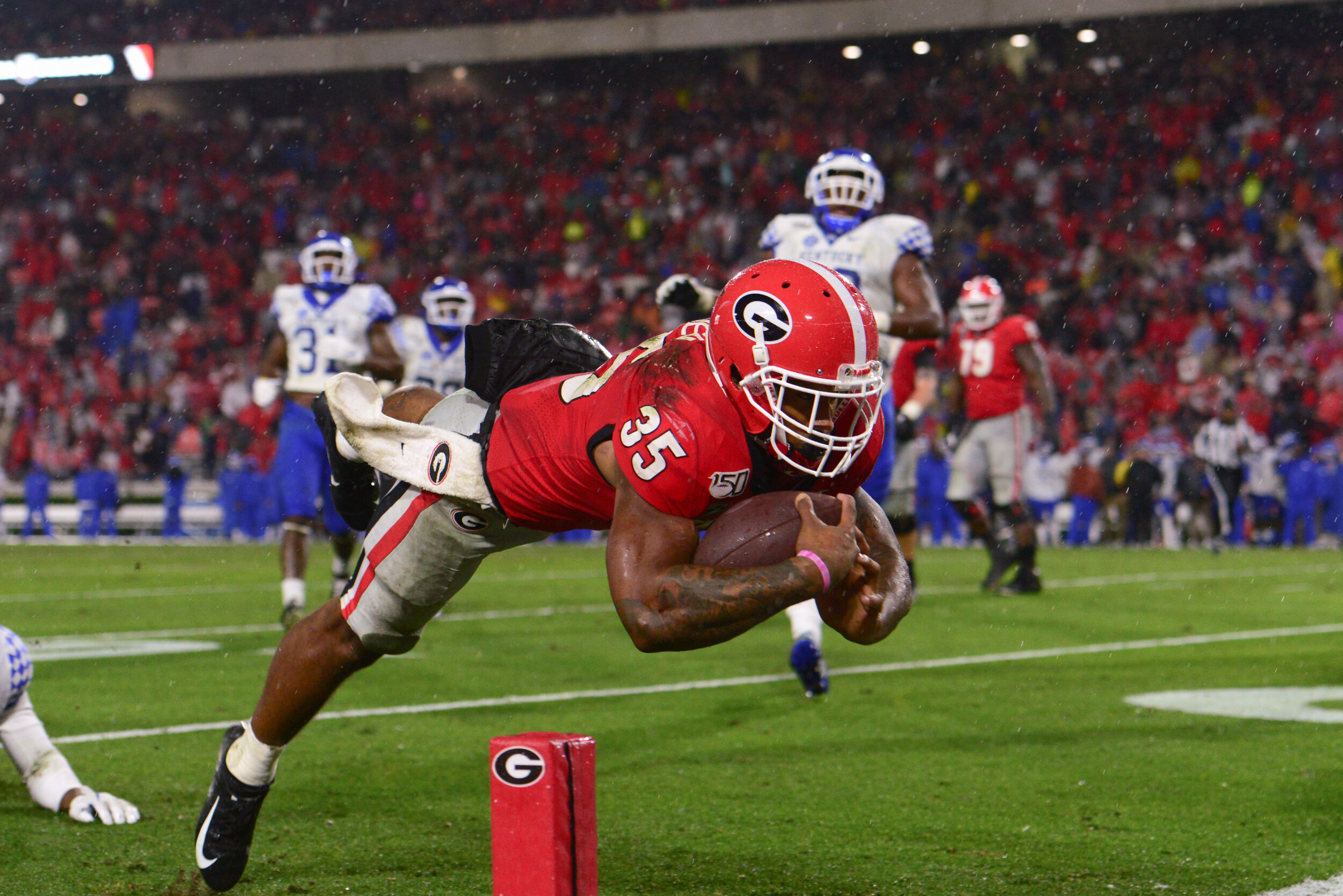  Georgia running back Brian Herrien (35) leaps into the end zone during a game against Kentucky on Oct. 19, 2019, in a soggy Sanford Stadium. Georgia defeated Kentucky 21-0. (Photo/Julian Alexander) 