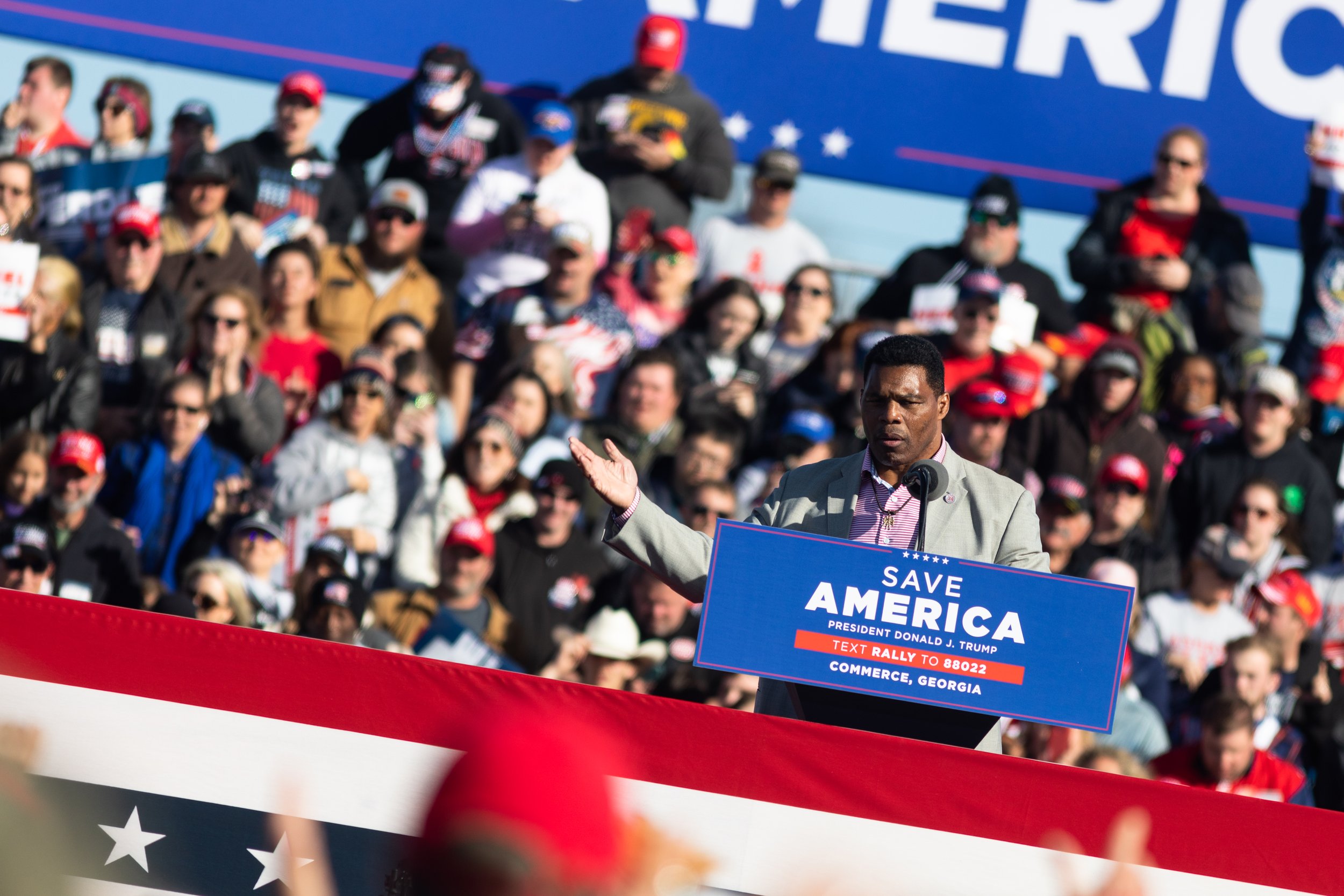  Former Georgia running back Herschel Walker speaks at a Save America rally at the Atlanta Dragway on Saturday, March 26, 2022 in Commerce, Georgia. Walker is a member of the 1980 Georgia Bulldogs football team that won the National Championship, and