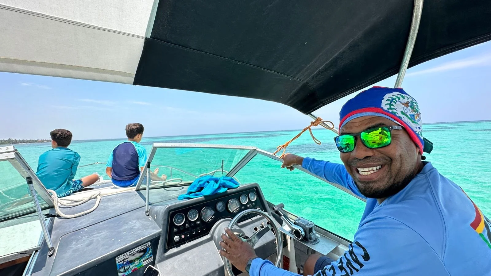 Captain Oliver on a boat in San Pedro, Belize, whose daily reef adventures inspire the seasonal seafood menu at Red Ginger.