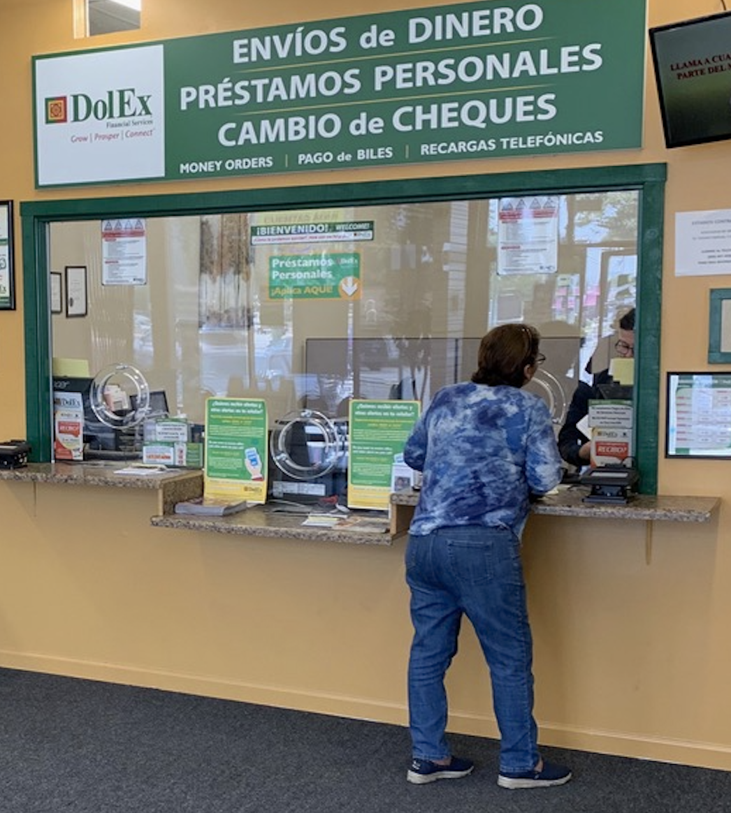 A customer talking to a sales associate at Dolex, one of Aura’s partners.