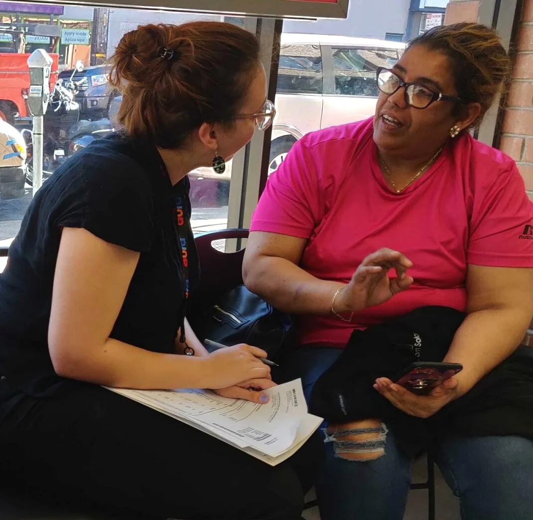 Photo of Lorena (left) conducting usability testing with a customer (right).