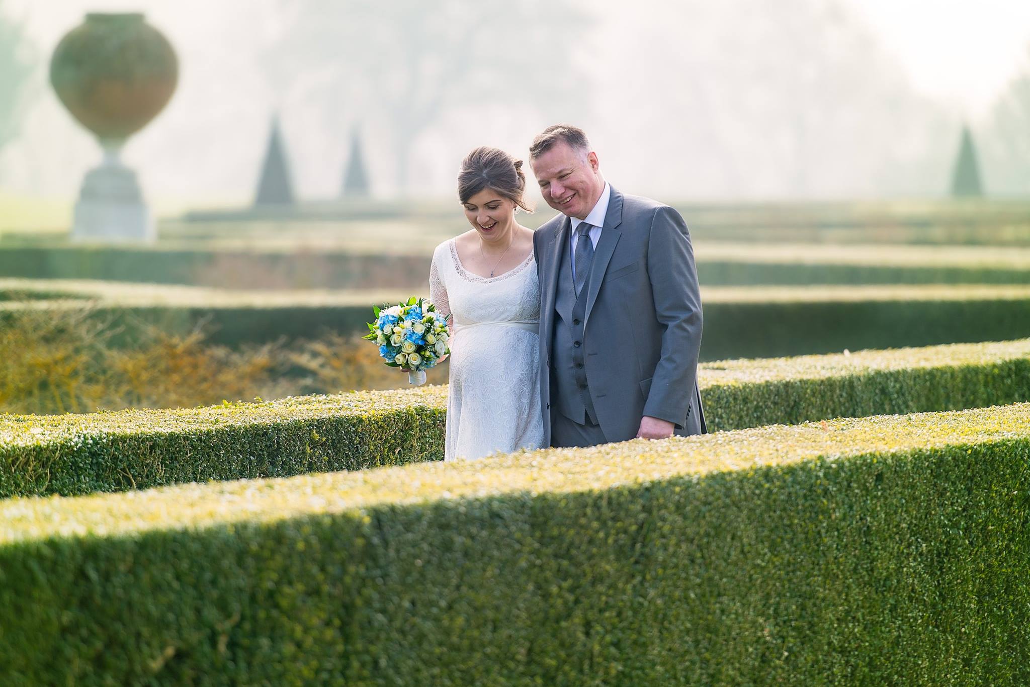 Wedding picture of a couple walking in the gardens of Cliveden House near Beaconsfield 