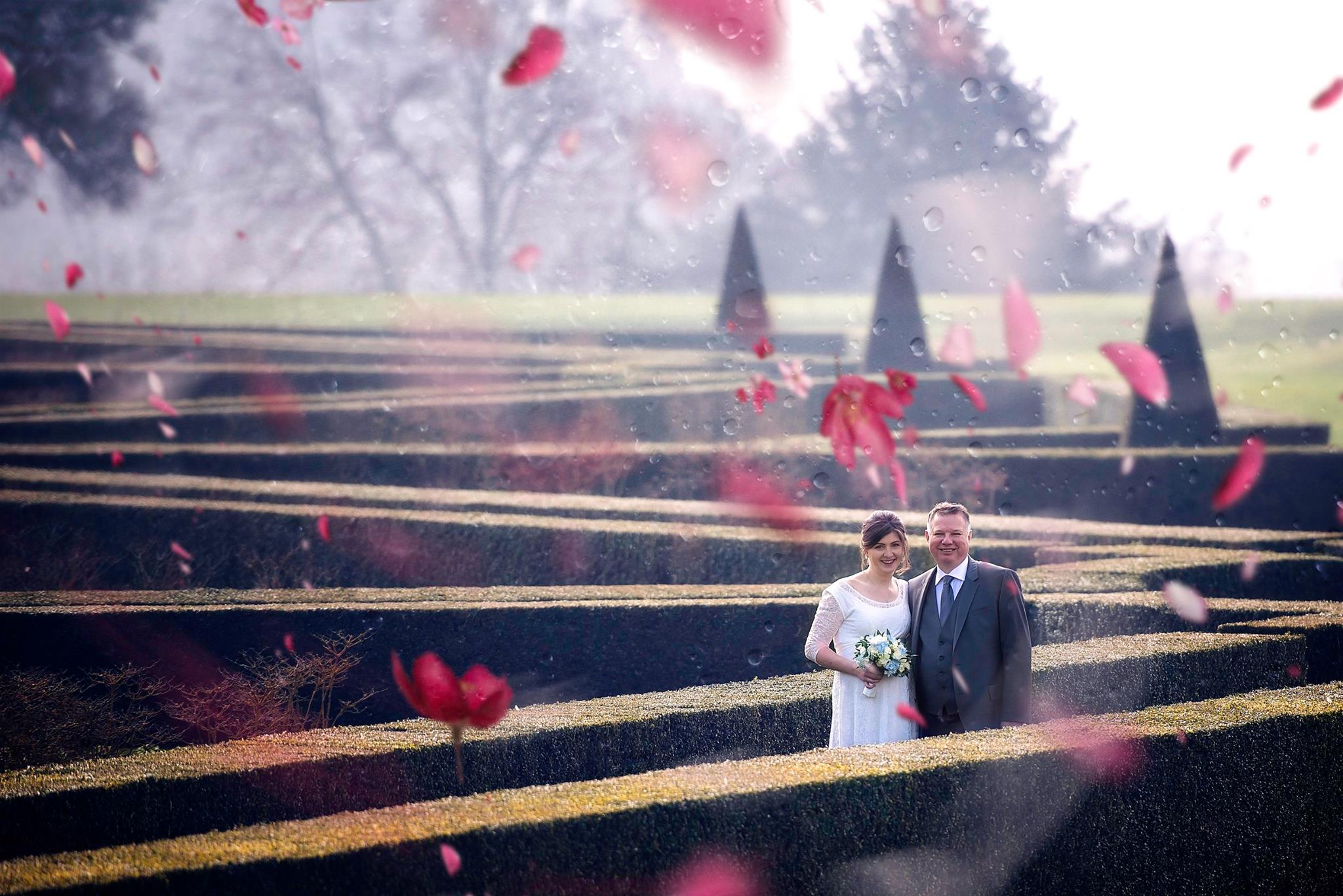 Creative photo edit of bride and groom walking in Cliveden House gardens