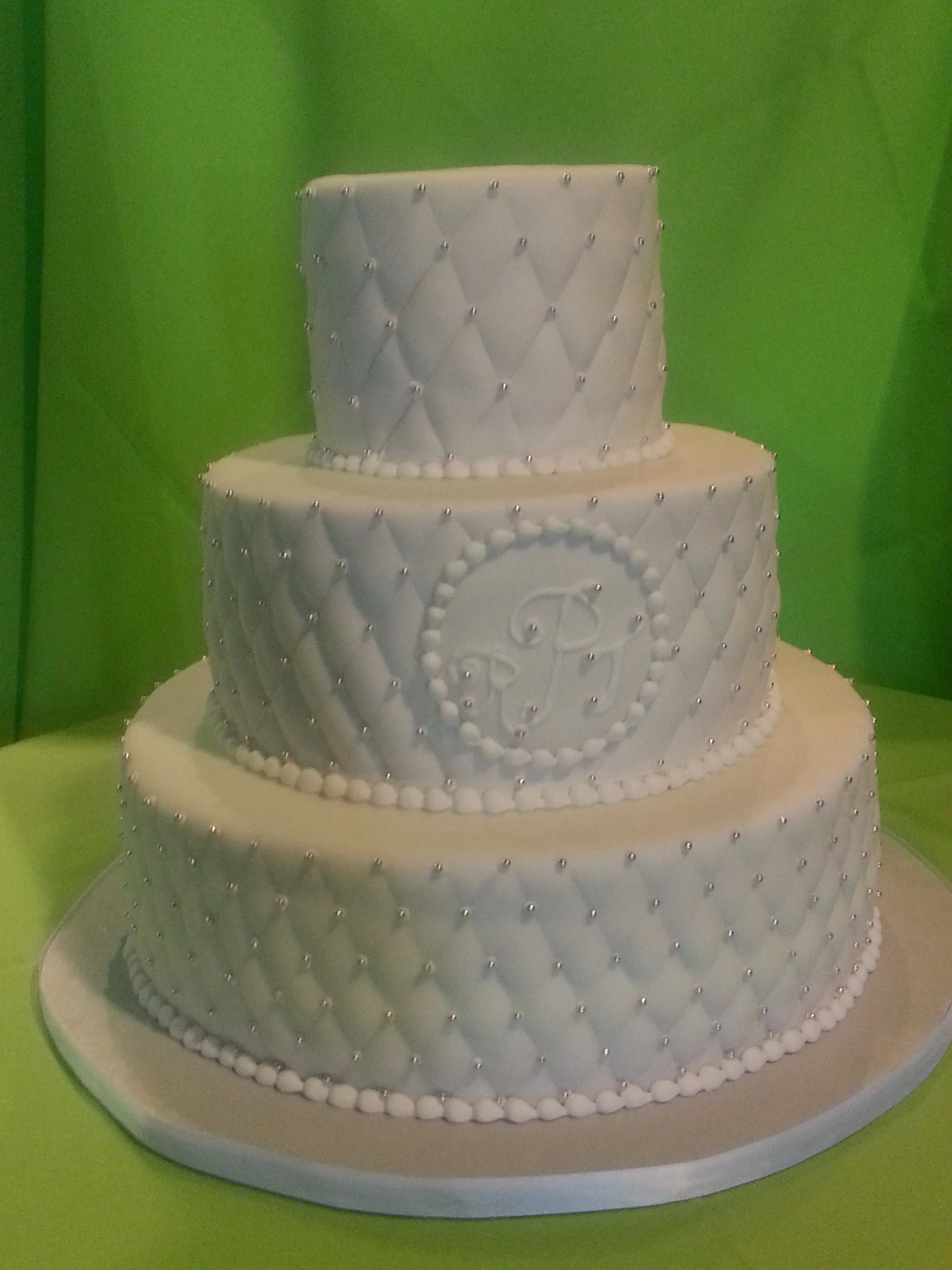 Simple, elegant, tufted-pearl white wedding cake