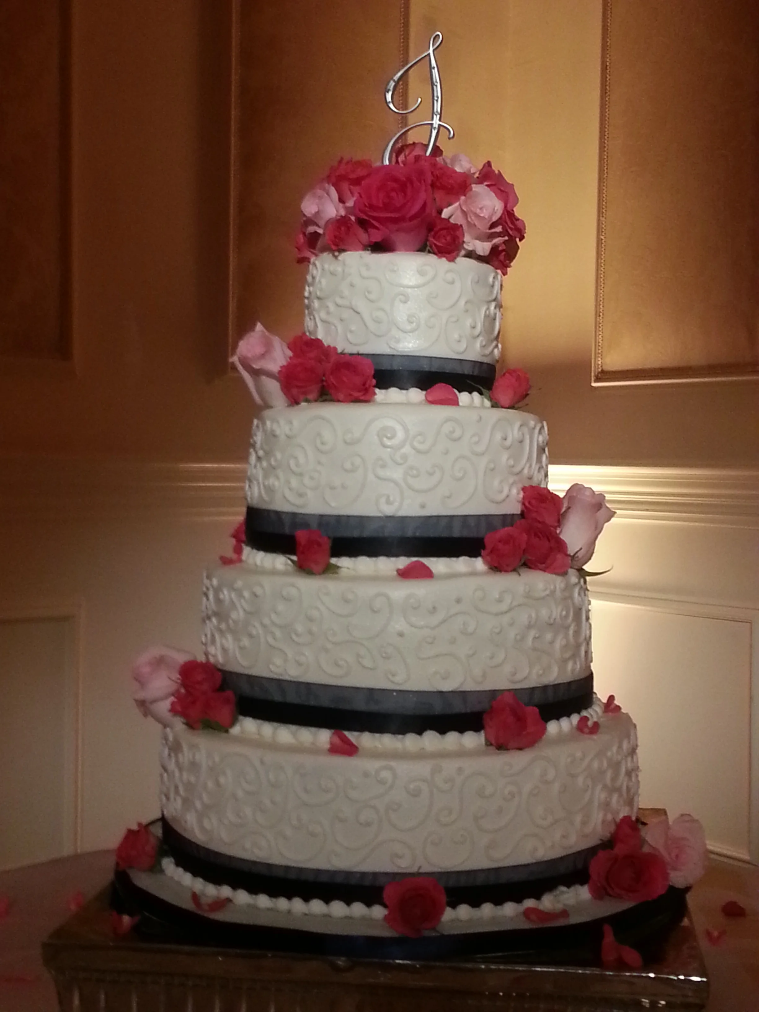 Red and pink roses towering wedding cake