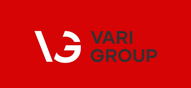 Red background with a stylized white and black logo and the text 'VARI GROUP' in black.