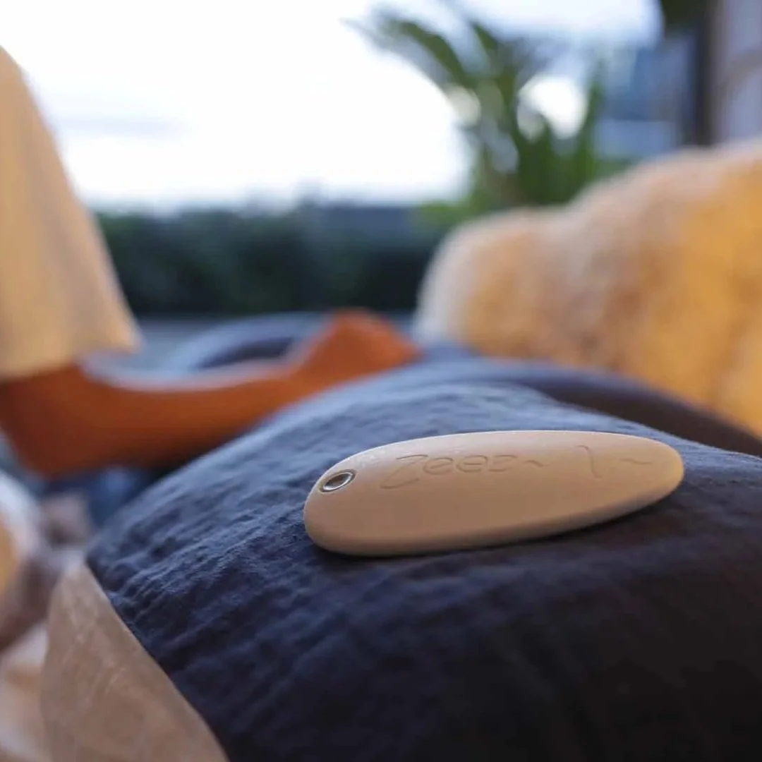 Zeez Sleep Pebble on a pillow