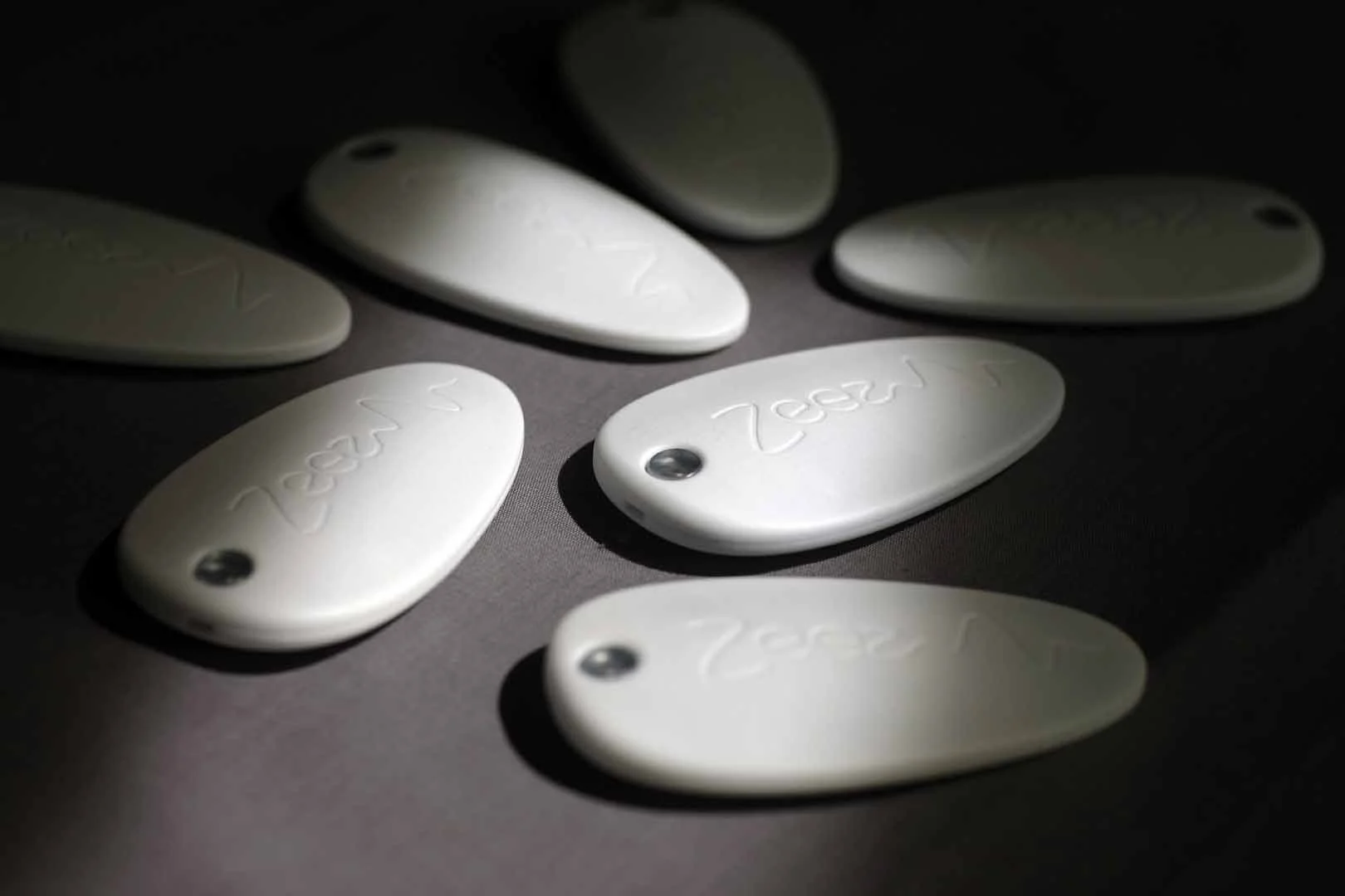 Several Zeez Sleep Pebbles on grey background