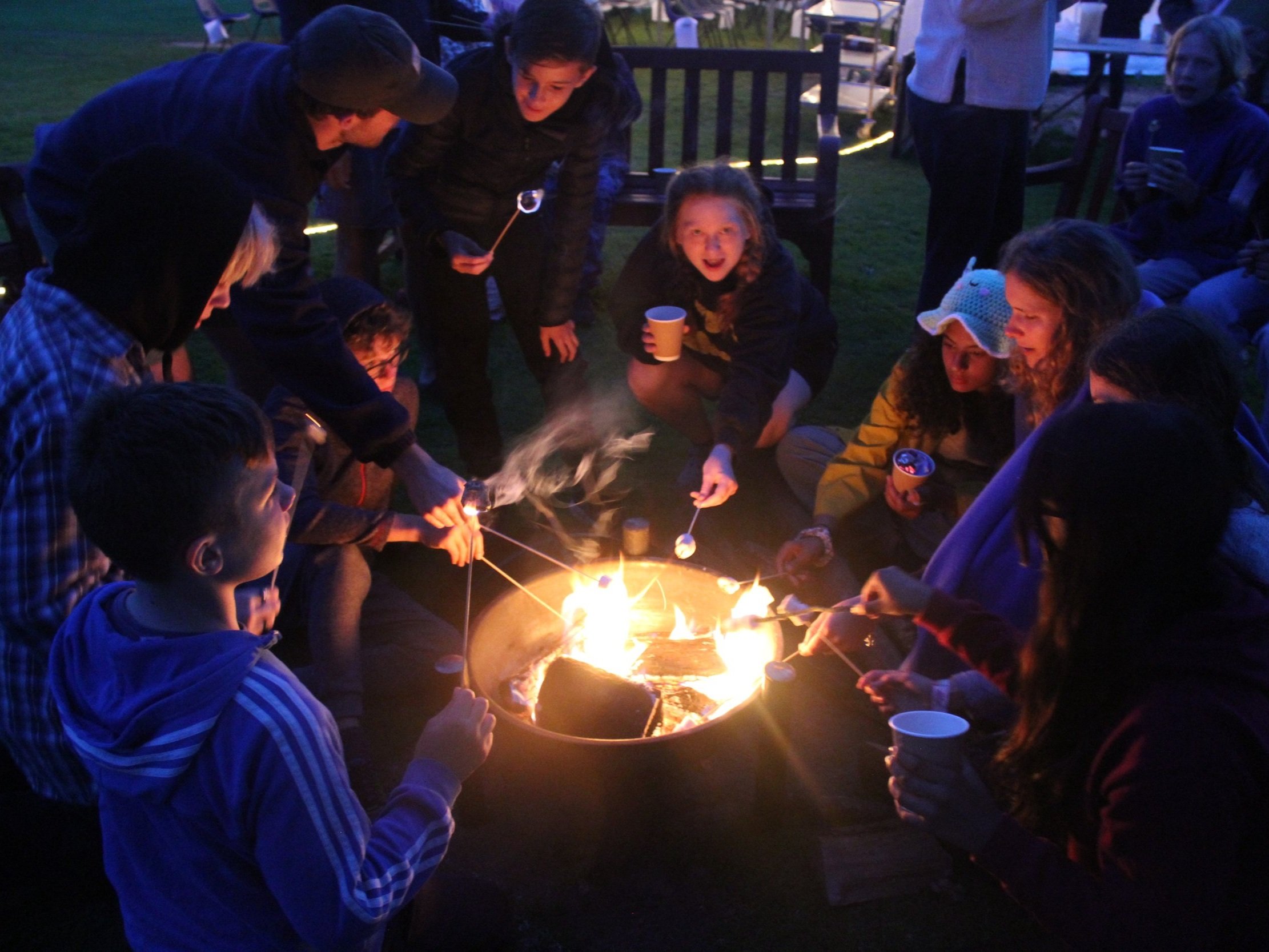 Toasting marshmallows around the campfire on summer camp