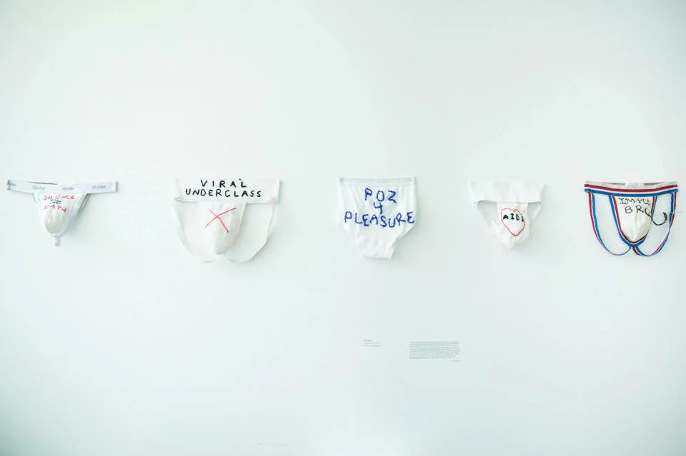 “In 2014 I embroidered these jocks and underwear I’d lived in since seroconversion summer of 2010. I embroidered in the hate I had stitch by stitch, weaving my first alchemical spell to transform my physical garments, which were in many ways a symbol of my pain and my fear, into the first spell for hope I could begin to muster while knocking on deaths door. I had accepted death. But I realized I could still choose to live despite it being a harder path. So I wove these words and sent a message into the universe that I had made an intention to fight and a dream to heal. These 5 garments were the first step in healing my heart, my mind, my spirit and my physical body. I began baby stepping my self away from fear based consciousness and into love.” -Vas via Facebook