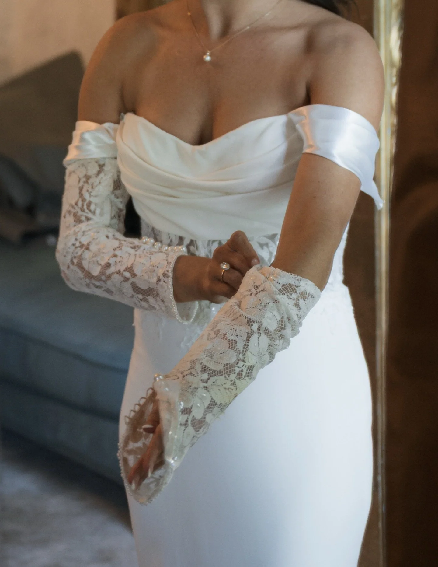 Another detail repurposed from her mother&rsquo;s wedding dress, fingerless lace gloves and removable satin draped sleeves made to complement her existing ceremony dress.