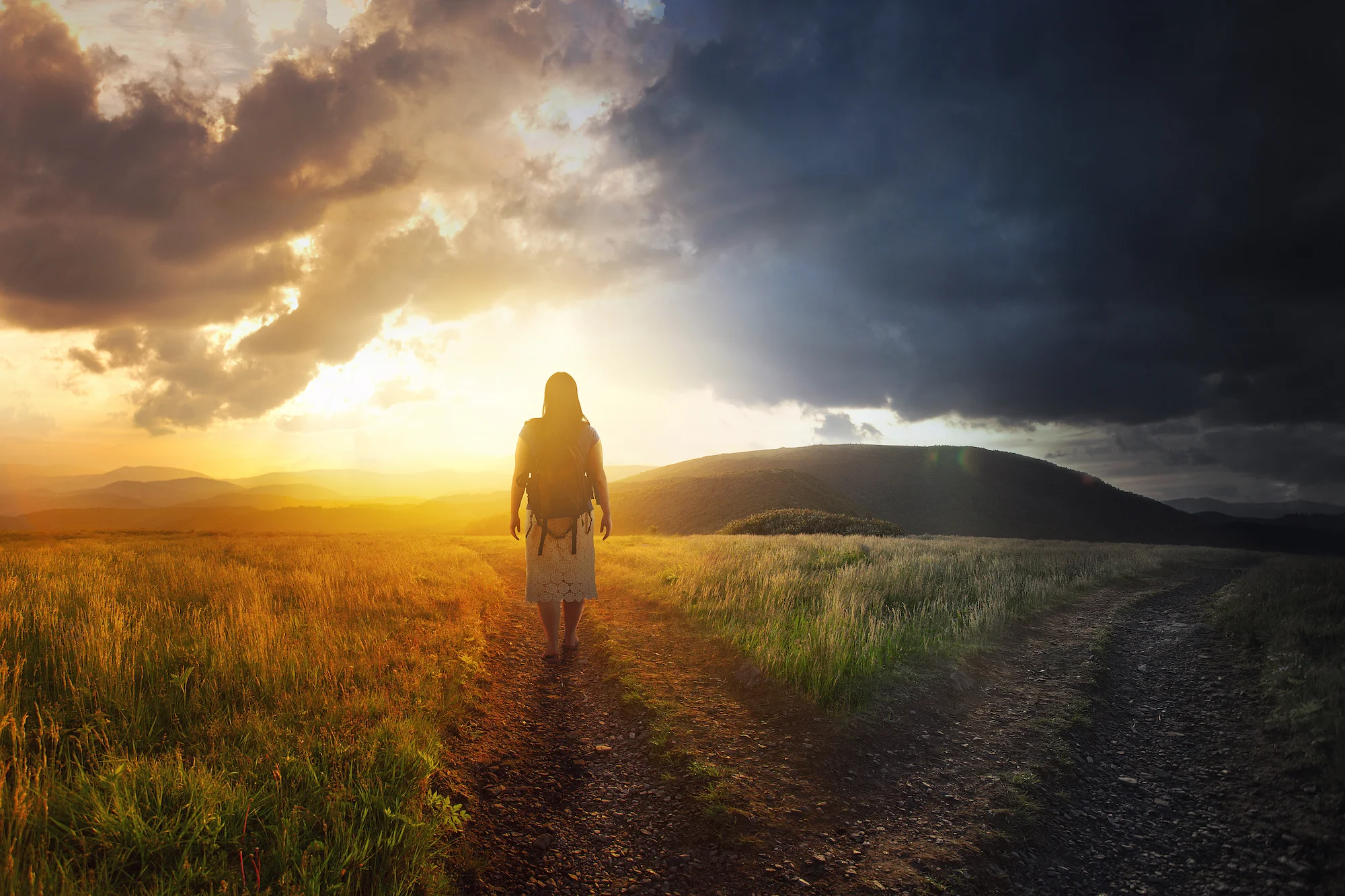 a-woman-walks-down-a-path-towards-light_rQ-ByGxA (2).jpg