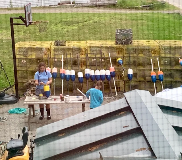 My kids working on their gear in the driveway. You can see the water from our house but this view is way better.